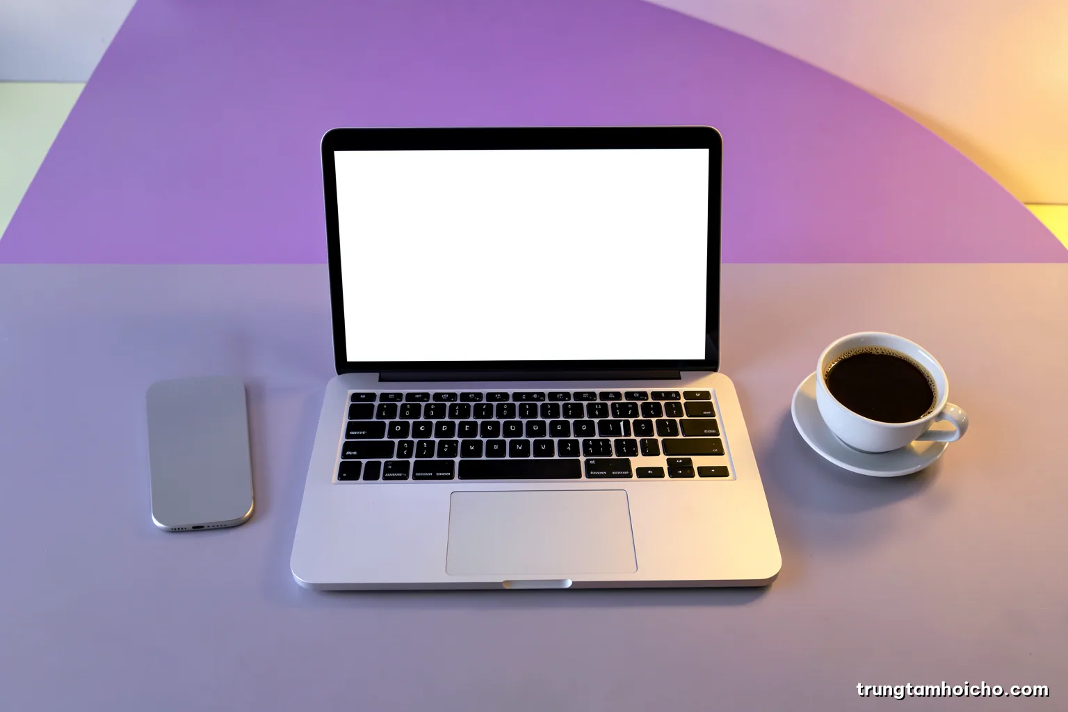 Top-down view of a minimalist desk with a laptop showing a blank white display, a smartphone and a coffee cup, crisp natural light, cool grey and lime accents